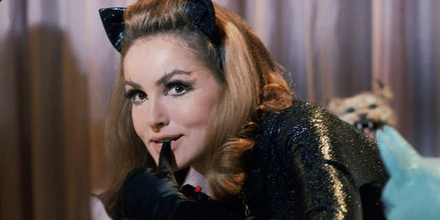Julie Newmar biting her thumb in costume as Catwoman