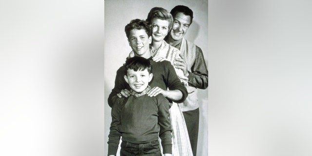 The cast of Leave It to Beaver smiling in a black and white photo