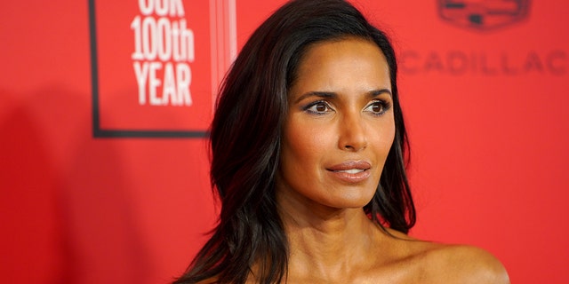 A close-up of Padma Lakshmi against a red backdrop