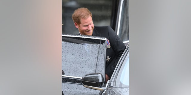 Prince Harry in his morning suit entering a black car