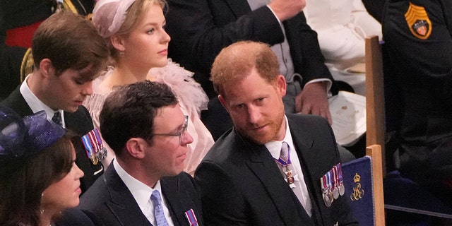 Prince Harry in his morning suit chatting with Jack Brooksbank