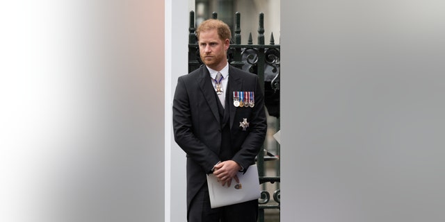 Prince Harry standing in his morning suit