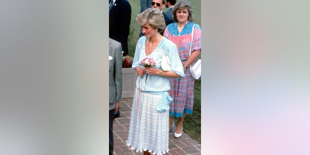 Princess Diana in a light blue and pink dress