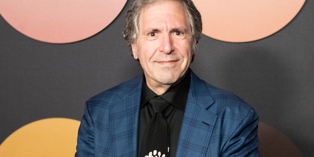 Robert Levine wearing a blue blazer and black shirt