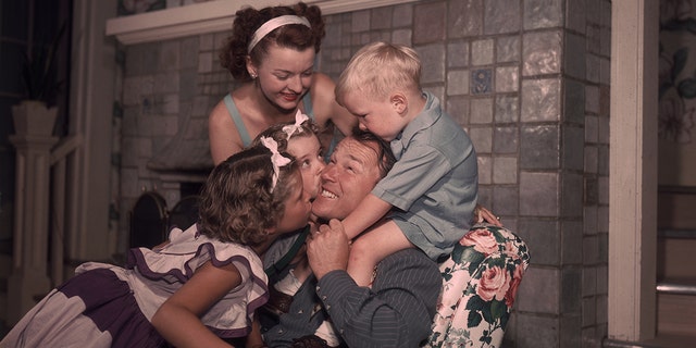 Rog Rogers and Dale Evans being embraced by their children
