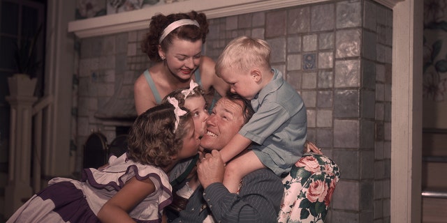 Rog Rogers and Dale Evans being embraced by their children