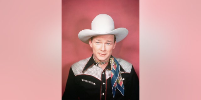 a close-up of Roy Rogers wearing a cowboy hat and a scarf