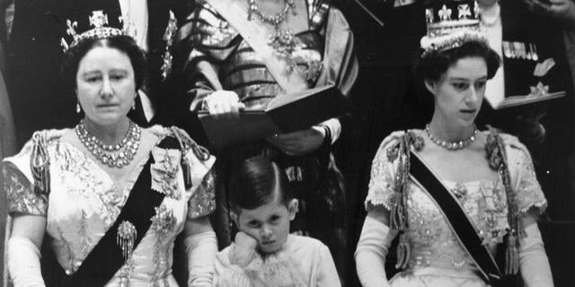 Prince Charles looking tired in between his grandmother and aunt during his mothers coronation