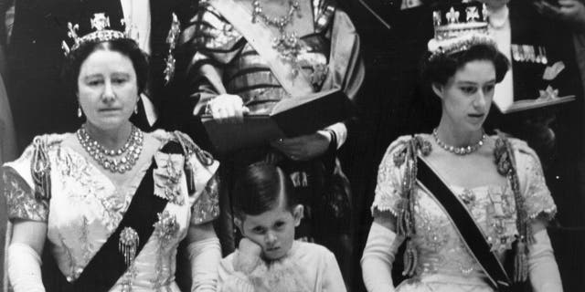 Prince Charles looking tired in between his grandmother and aunt during his mothers coronation