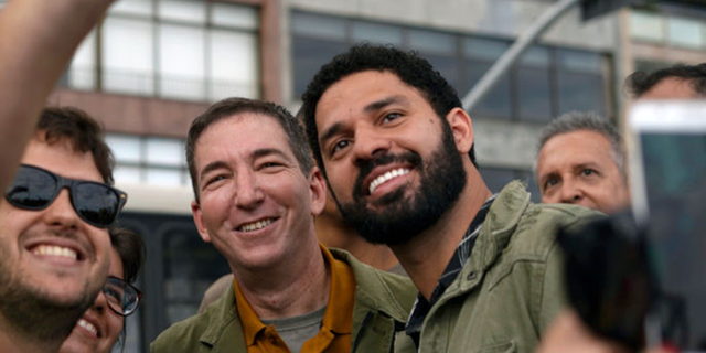 Greenwald and his husband photographed