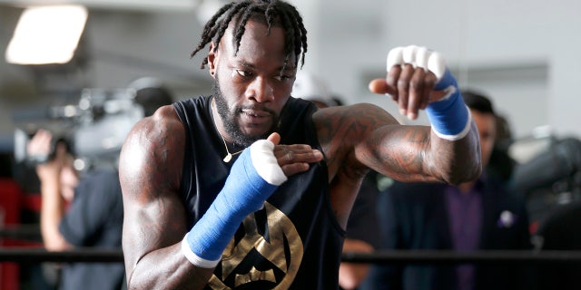 Deontay Wilder shadowboxes