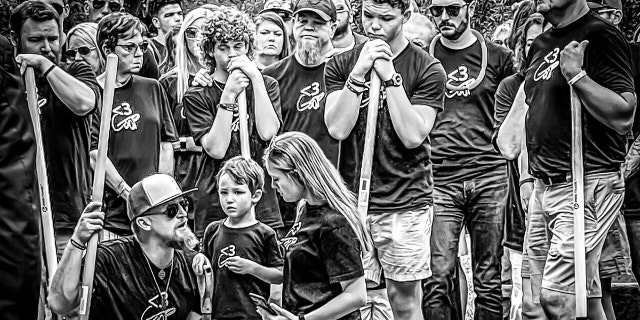 The Guffey family gathers at Gavin's funeral holding shovles