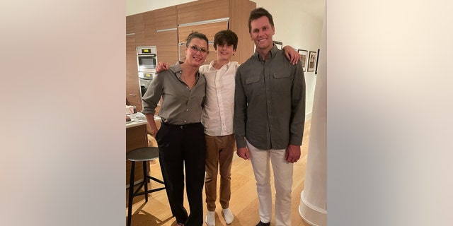 Tom Brady smiles for a photo with his son Jack, nearly as tall as him, with his mother Bridget Moynahan