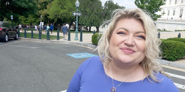 Rep. Kat Cammack looks into the camera while crossing the street on Capitol Hill.