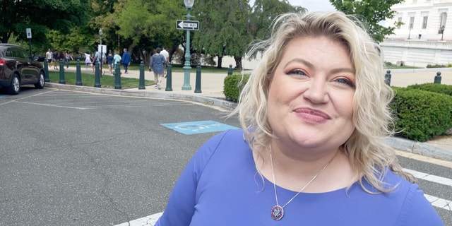 Rep. Kat Cammack looks into the camera while crossing the street on Capitol Hill.