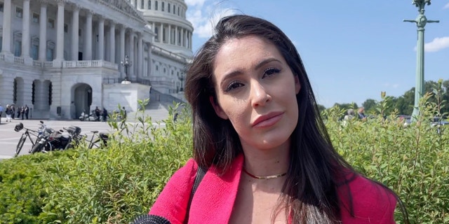 Rep. Anna Paulina Luna interviewing with the dome of the U.S. Capitol behind her.