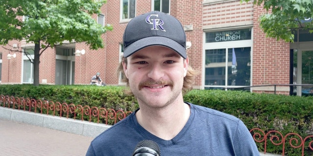 John interviews on the sidewalk in South East Washington, D.C.