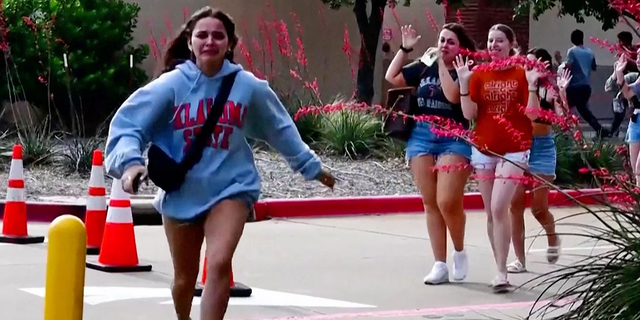 A girl is running away from a mall after a shooting