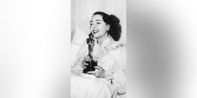 Joan Crawford Holding Academy Award