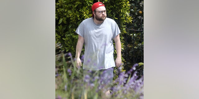 Angus T. Jones sported a backwards red cap and grey shirt while out and about in Los Angeles.