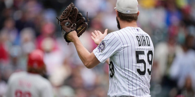 Jake Bird claps at the dugout