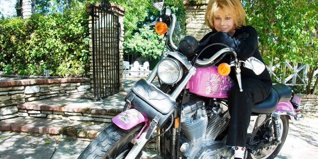 Ann-Margret sitting on her Harley-Davidson