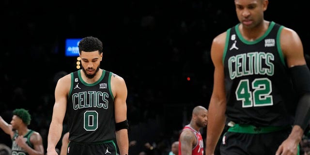 Celtics players walk off the court