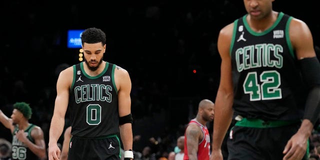 Celtics players walk off the court