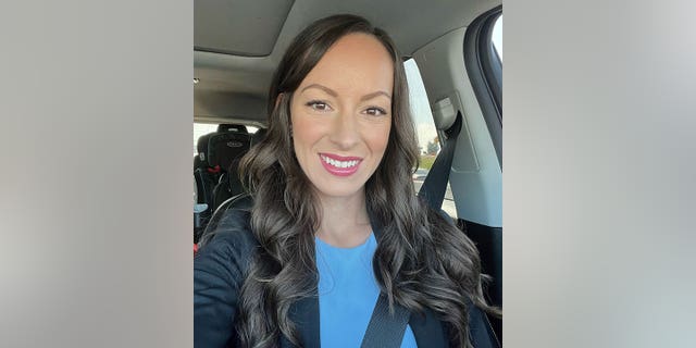 Jessica Tapia smiles in car selfie with child safety seat in the back