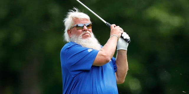 John Daly finishes the swing