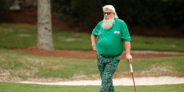John Daly waits to putt
