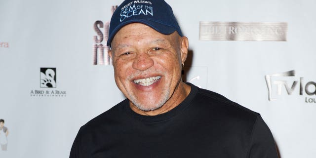 John Beasley smiles on the red carpet