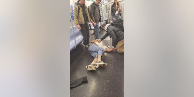 Jordan Neely on the floor of subway car unconscious