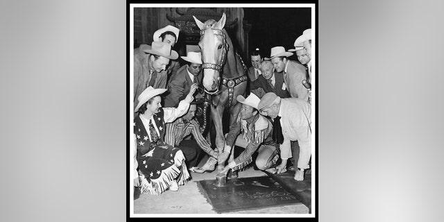 Roy Rogers posing with his horse Trigger