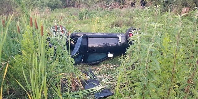 KIA flipped over in grass