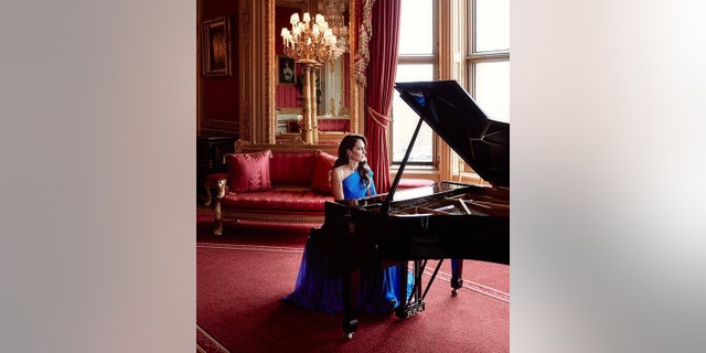 Kate Middleton plays the piano in a long Jenny Packham gown for Eurovision, filmed in the Crimson Drawing Room 