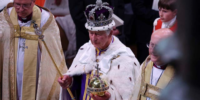 Britains King Charles departs following their coronation ceremony at Westminster Abbey