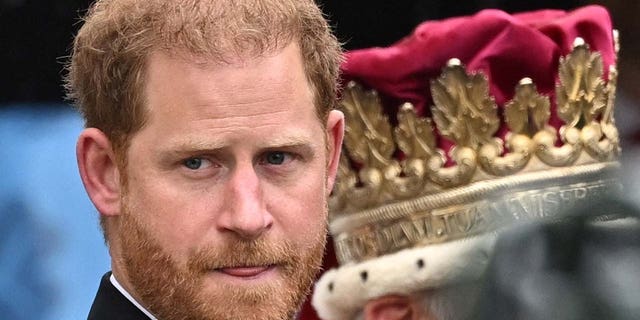 Britain's Prince Harry walks outside Westminster Abbey