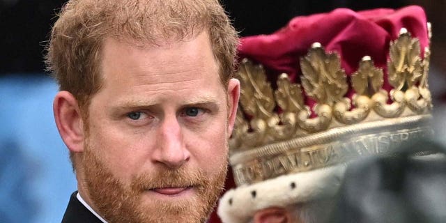 Britain's Prince Harry walks outside Westminster Abbey