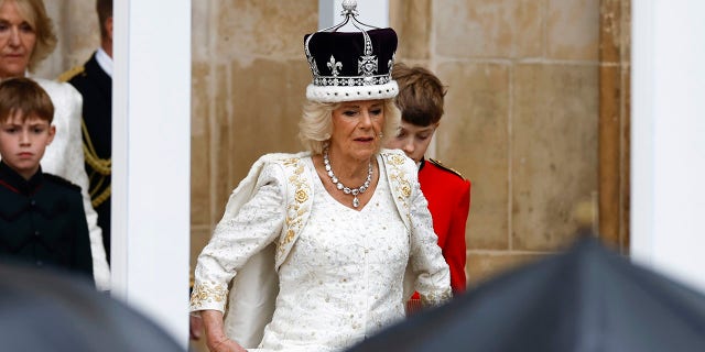 Camilla wearing a white goiwn with a crown