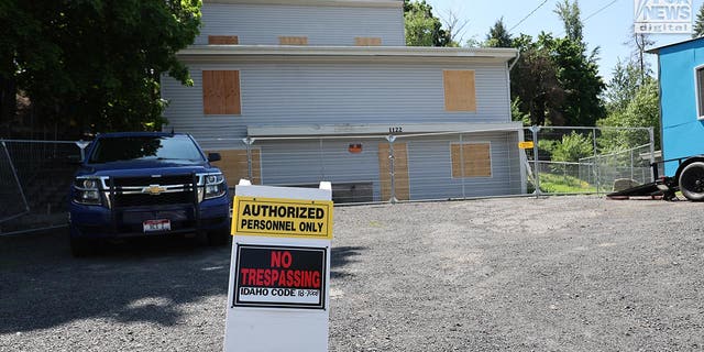 Trespassing sign out front of University of Idaho home with blue truck parked out front