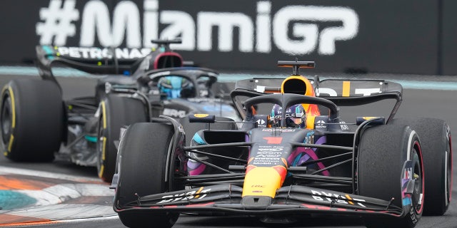 Max Verstappen battles George Russell