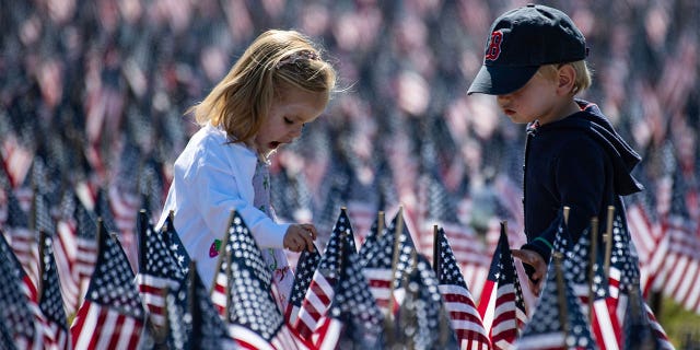 Children playing, surrounded by flags.