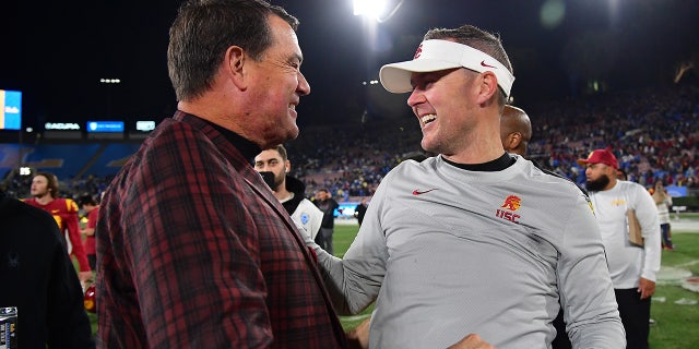 Mike Bohn celebrates with Lincoln Riley