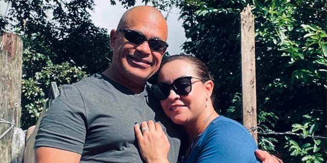 Domingo Tavarez-Rodriguez and Yenitzia Torres wearing sunglasses and hugging