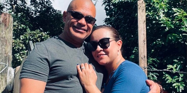 Domingo Tavarez-Rodriguez and Yenitzia Torres wearing sunglasses and hugging