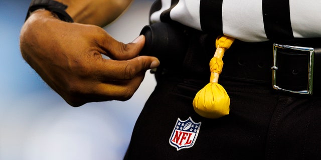 Árbitro de la NFL con una bandera en la mano