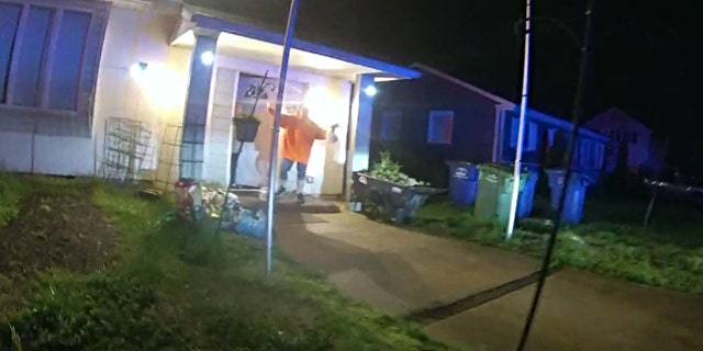 Ruth Patton motions toward officers as Marc Ferraiolo puts his car in reverse