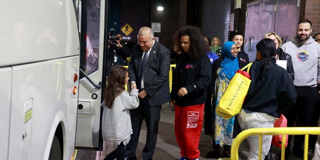 Mayor's Office of Immigrant Affairs Commissioner Manuel Castro (C) a former illegal immigrant himself, welcomes migrants arriving at the Port Authority Bus Terminal