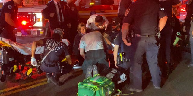 Two NYC police officers struck and dragged by fleeing vehicle: NYPD 2 EMTs on the street helping injured officers.